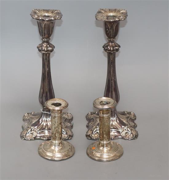 A pair of plated candlesticks and one pair of small silver candlesticks tallest 26cm